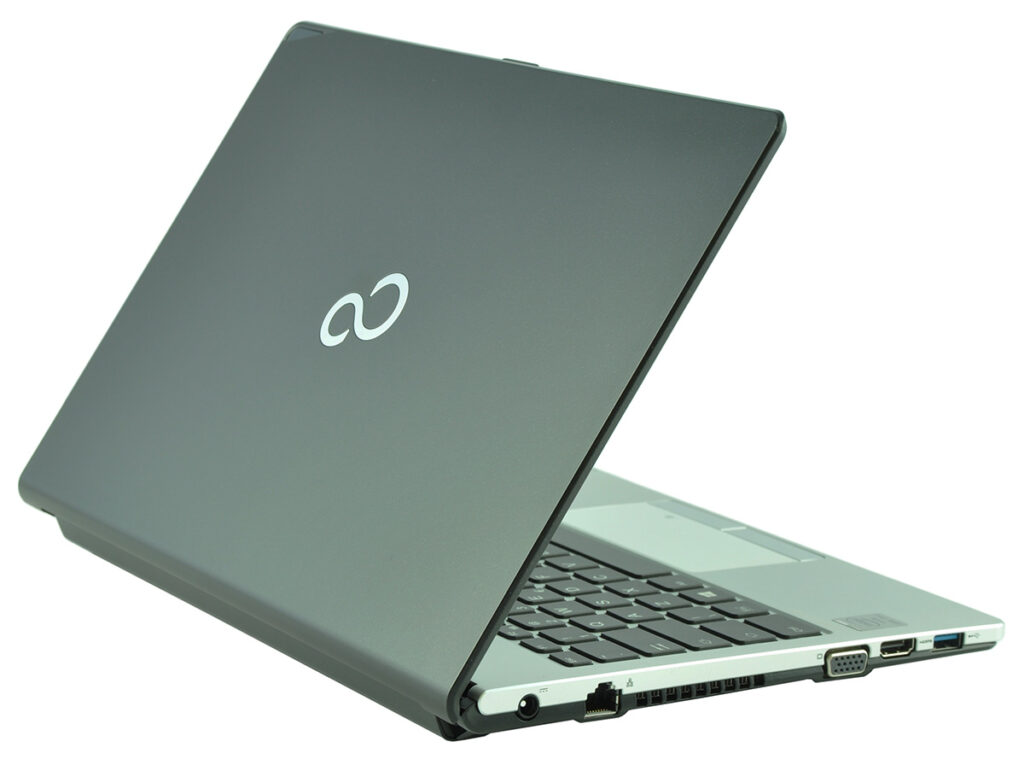 Open laptop shown at an angle with a dark lid and a light logo on the back, showing keyboard side and ports.