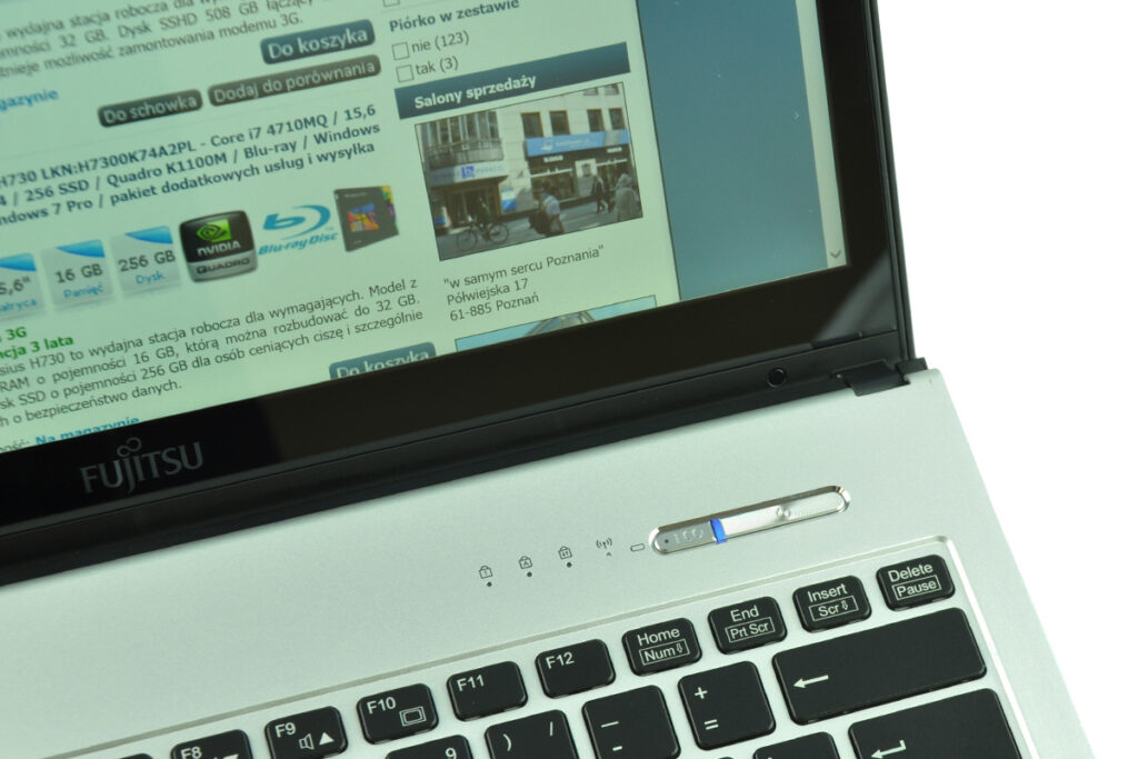 Laptop with an open browser showing a Polish shopping site, Fujitsu branding visible on the chassis.