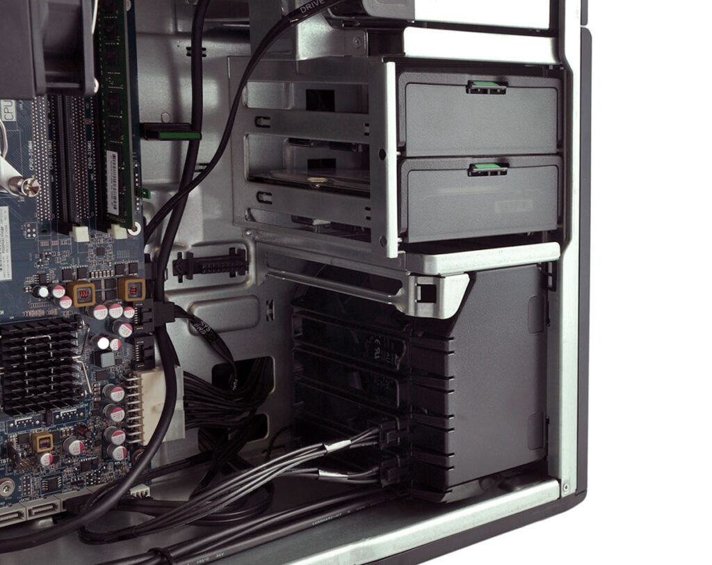 Interior of a desktop PC: motherboard with RAM, expansion slots, cables, and drive bays visible inside the case.