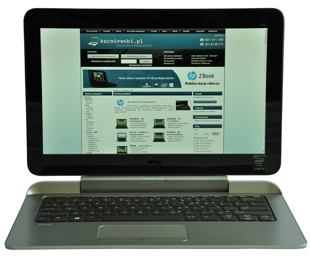 Open laptop displaying a website on the screen, featuring a blue header and product images in the page layout.