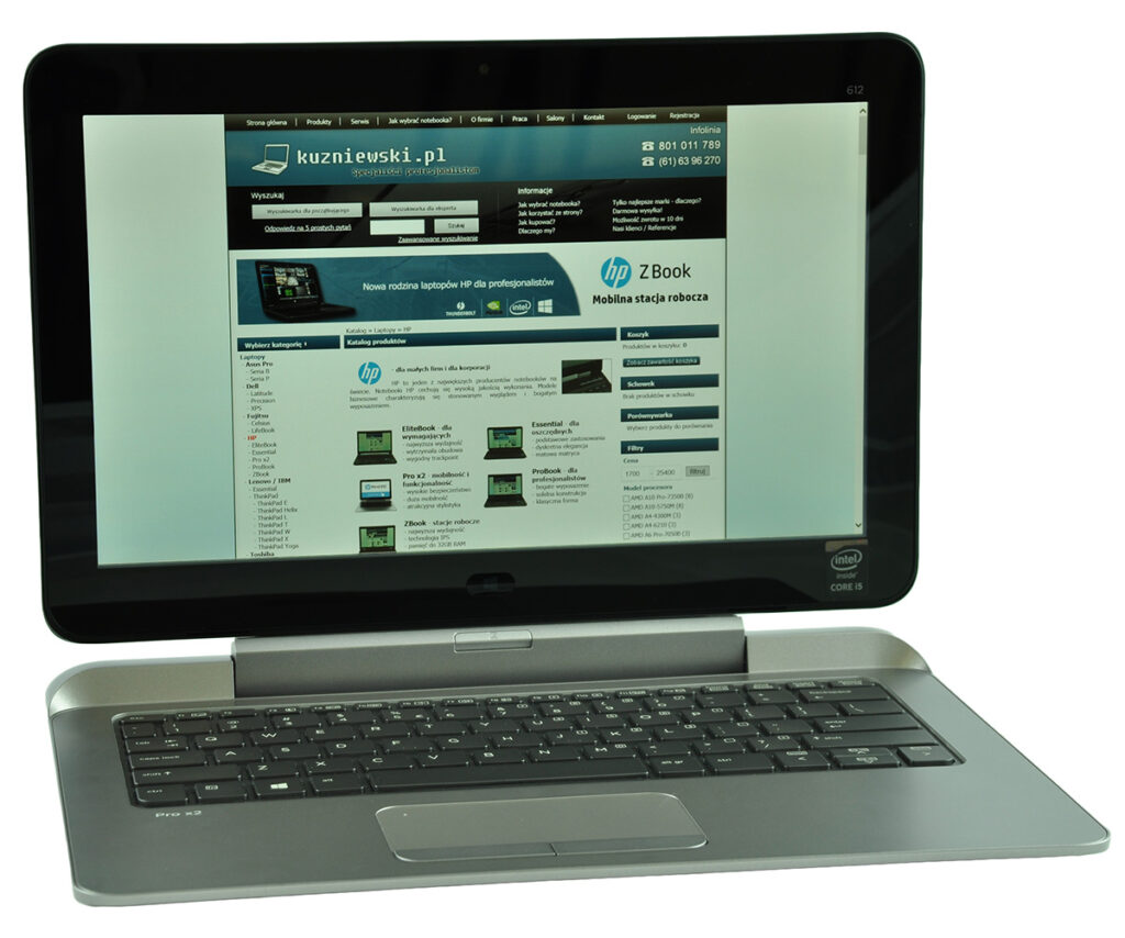 laptop-hp-probook-x2-612-3 - lab-kuzniewski.pl - Testy laptopów, recenzje i porównania Open silver laptop displaying a Polish tech retailer homepage on the screen (blue header and product listings).