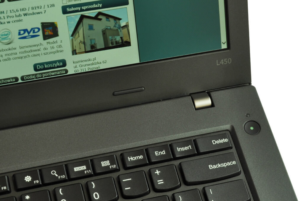 laptop-lenovo-thinkpad-l450-8 - lab-kuzniewski.pl - Testy laptopów, recenzje i porównania Close-up of a dark laptop with a Polish web page visible on the screen and a green power button area; model L450 partially shown.