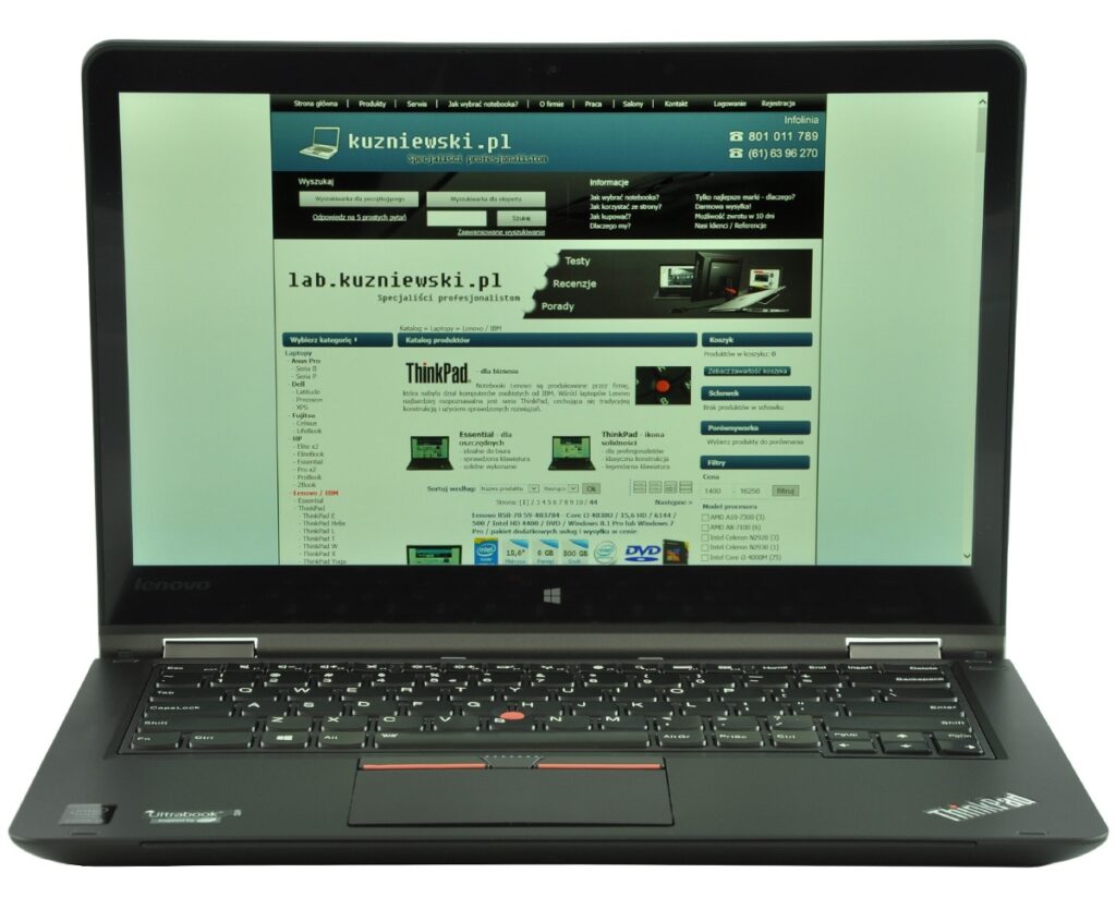 lenovo-thinkpad-yoga-14_131819 - lab-kuzniewski.pl - Testy laptopów, recenzje i porównania Lenovo ThinkPad laptop open, displaying a Polish tech website on the screen with a blue header and multiple sections.