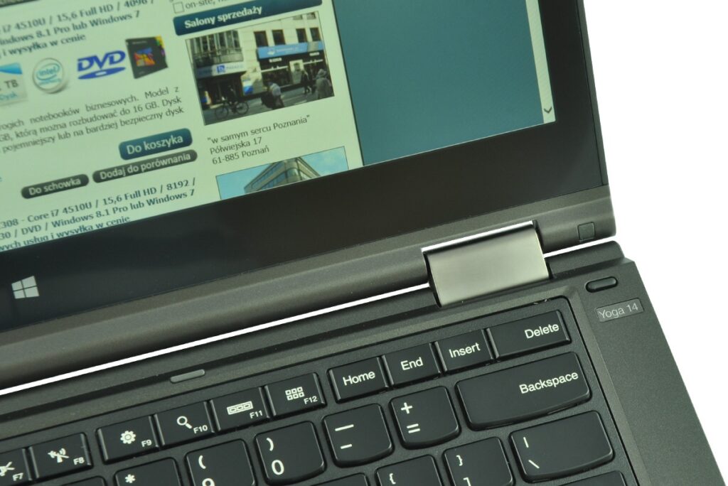 lenovo-thinkpad-yoga-14_131825 - lab-kuzniewski.pl - Testy laptopów, recenzje i porównania Close-up of a black laptop with a visible Windows key and a web page open on the screen.