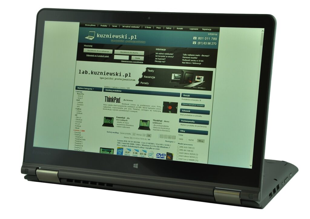 lenovo-thinkpad-yoga-14_131827 - lab-kuzniewski.pl - Testy laptopów, recenzje i porównania Convertible laptop with kuzniewski.pl homepage displayed on the screen, showing a Polish electronics retailer site.