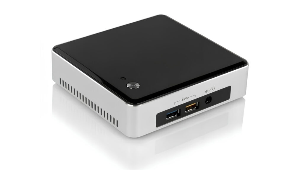 Compact mini PC with a glossy black top and white body, showing two USB ports, an Ethernet port, and a power input on the side panel.