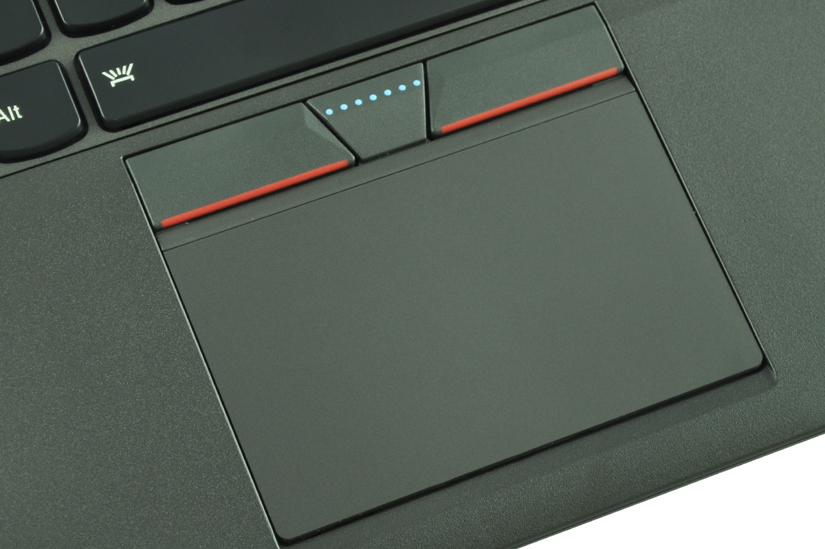 laptop-lenovo-thinkpad-x250-5 - lab-kuzniewski.pl - Testy laptopów, recenzje i porównania Close-up of a laptop touchpad with two red buttons and a blue dotted status indicator above the pad.
