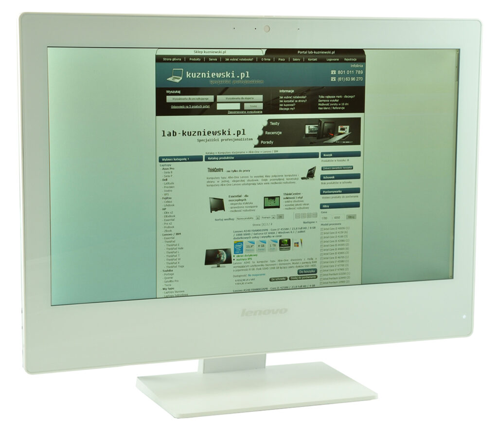 Lenovo computer monitor on a white stand displaying a Polish website layout on screen