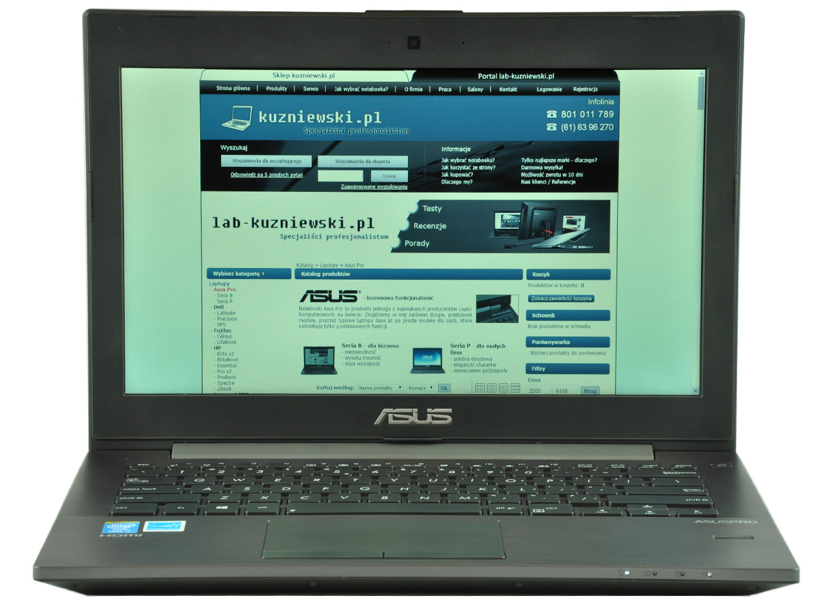 Laptop opened to show a blue/teal website on screen, branding ASUS visible on lid and palm rest.