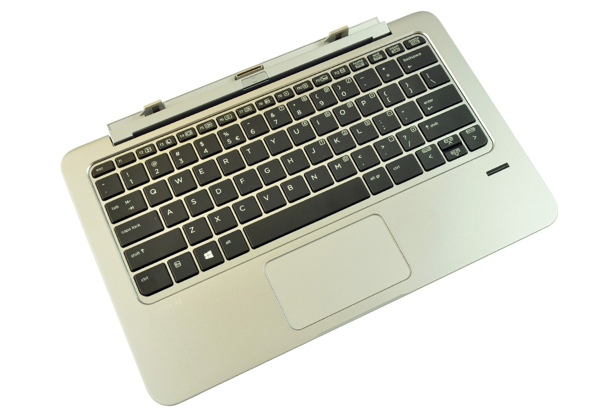 Top-down view of a silver laptop keyboard and touchpad on a white background