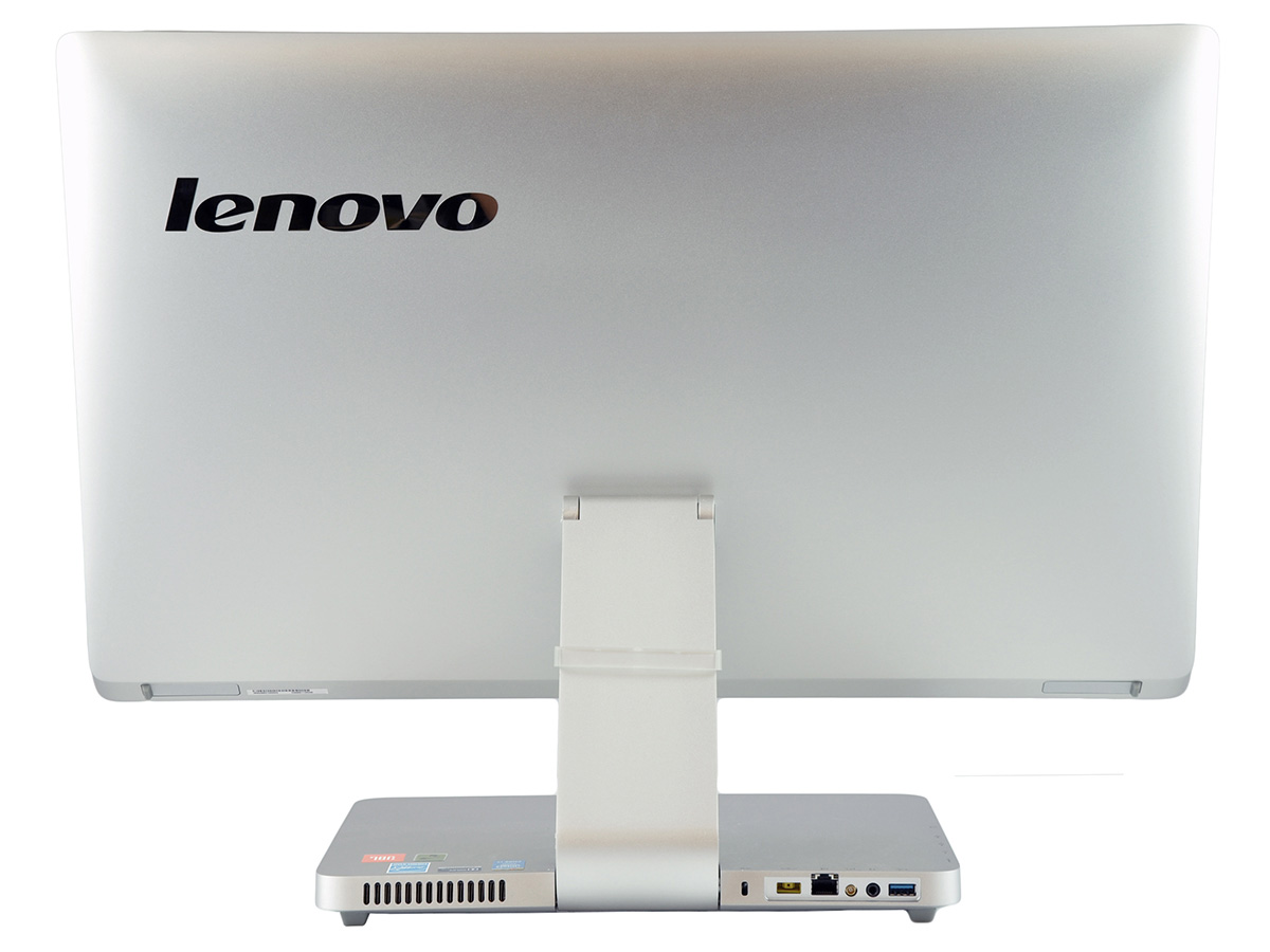 lenovo-a540-f0an0029pb-c_132537 - lab-kuzniewski.pl - Testy laptopów, recenzje i porównania Back view of a silver Lenovo all-in-one computer on a stand, with I/O ports visible along the lower rear edge