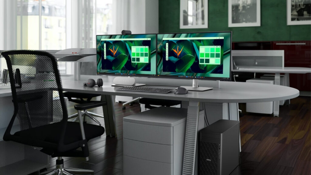 Dell Pro Max Tower FCT2250_3008_0004 - lab-kuzniewski.pl - Testy laptopów, recenzje i porównania Dual-monitor computer workstation on a curved white desk with a webcam, keyboard, mouse, and Dell desktop in an open office. won