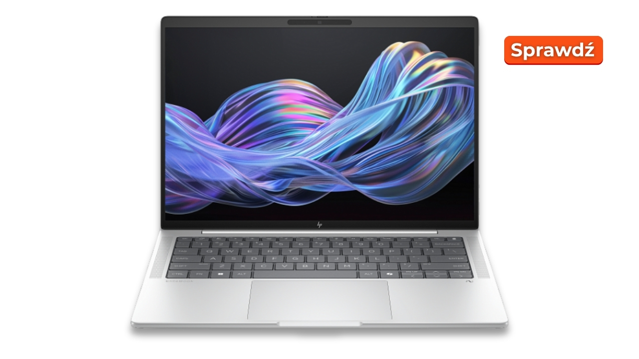 Open silver laptop displaying a colorful abstract wallpaper; orange 'Sprawdź' badge appears in the top-right corner.