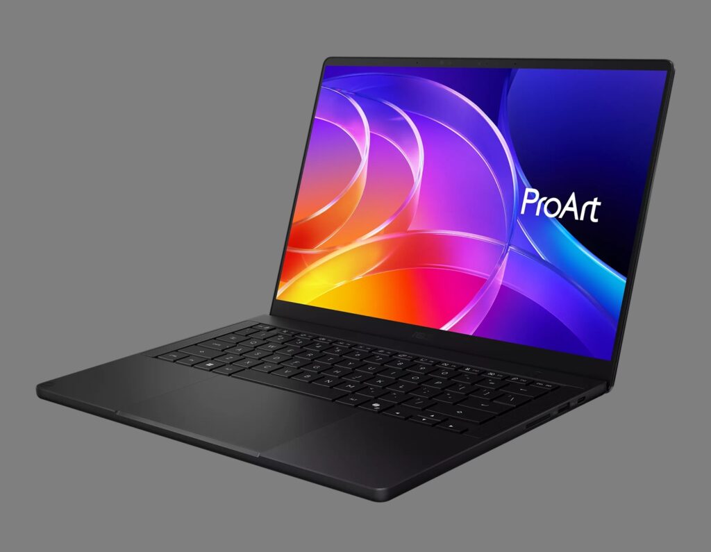 Slim black laptop open at an angle displaying a vibrant ProArt screen with colorful abstract graphics.
