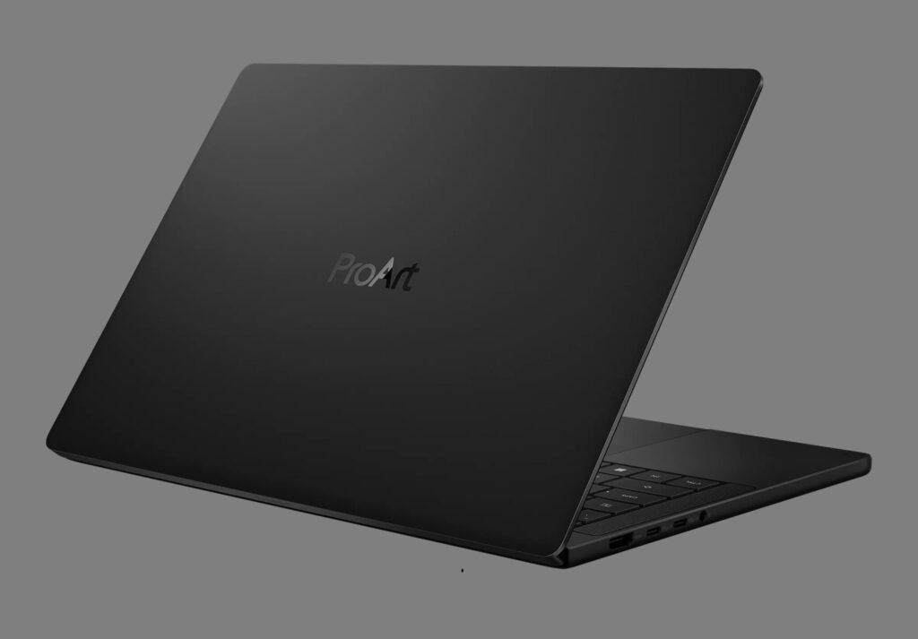 Slim black laptop angled open, ProArt logo on the lid visible.