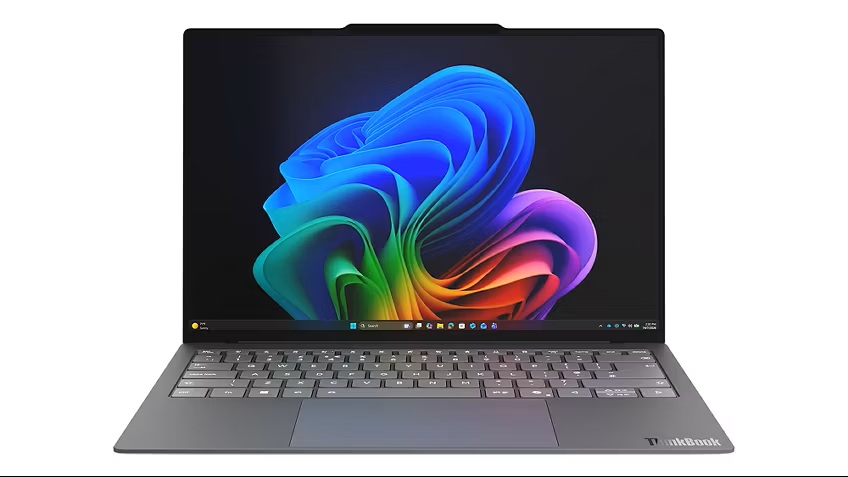 Lenovo Project AeroBlade_01 - lab-kuzniewski.pl - Testy laptopów, recenzje i porównania Open gray ThinkBook laptop displaying a vivid abstract rainbow wallpaper on the screen.