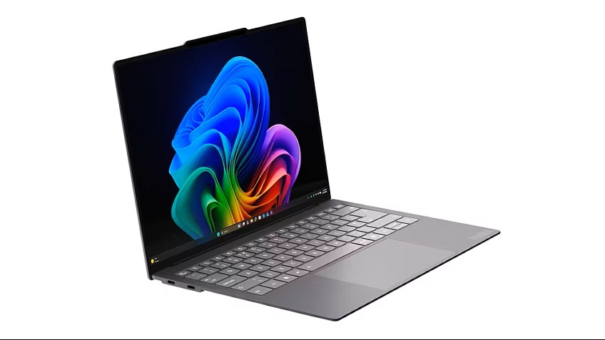 Lenovo Project AeroBlade_03 - lab-kuzniewski.pl - Testy laptopów, recenzje i porównania Slim gray laptop opened at a ~45-degree angle showing a vibrant abstract wallpaper on screen while resting on a white background.