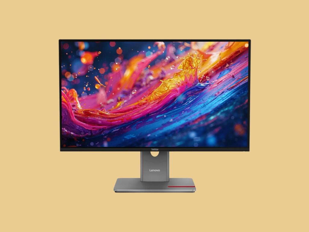Lenovo ThinkVision P27UL-40_01 - lab-kuzniewski.pl - Testy laptopów, recenzje i porównania Lenovo ThinkVision monitor on a stand displaying a vibrant abstract wallpaper against a beige background.