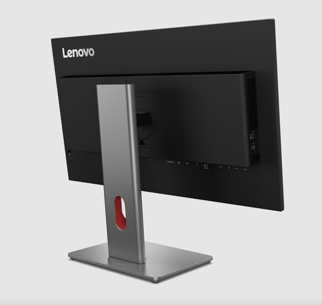 Screenshot - lab-kuzniewski.pl - Testy laptopów, recenzje i porównania Lenovo all-in-one monitor seen from the rear on a silver stand with ports on the side of the back panel -- branding visible on top left.